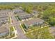 An aerial view of modern townhomes in a well-maintained community with lush green landscaping at 2718 Chestnut Creek Pl, Brandon, FL 33510