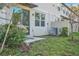 This home has a private backyard area with lawn and mature plants near the back entrance at 2718 Chestnut Creek Pl, Brandon, FL 33510