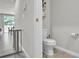 Cozy half bath featuring a modern toilet, storage shelf and tile flooring at 2718 Chestnut Creek Pl, Brandon, FL 33510