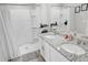 Bright bathroom featuring a shower and double sinks with granite countertops at 2718 Chestnut Creek Pl, Brandon, FL 33510