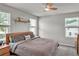 Cozy main bedroom featuring multiple windows and neutral wall coloring at 2718 Chestnut Creek Pl, Brandon, FL 33510