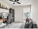 Bedroom featuring plush gray sofa, black cabinet, and a window at 2718 Chestnut Creek Pl, Brandon, FL 33510