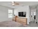 Bright bedroom with modern furnishings, ceiling fan, and easy access to the hallway at 2718 Chestnut Creek Pl, Brandon, FL 33510