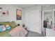 Bright bedroom featuring neutral walls, plush carpet, and a spacious closet with white doors at 2718 Chestnut Creek Pl, Brandon, FL 33510