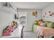 This bedroom features a bed with plush pillows, a desk, and decorative shelving at 2718 Chestnut Creek Pl, Brandon, FL 33510
