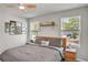 Comfortable bedroom with natural light, ceiling fan, and decorative accents at 2718 Chestnut Creek Pl, Brandon, FL 33510