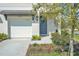 Close-up of a front entrance with a blue door and a white garage door on the side at 2718 Chestnut Creek Pl, Brandon, FL 33510