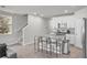 Open-concept kitchen featuring a granite island with seating adjacent to the living area and staircase at 2718 Chestnut Creek Pl, Brandon, FL 33510
