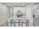 Bright kitchen features white cabinets, stainless steel appliances, and a granite island with seating at 2718 Chestnut Creek Pl, Brandon, FL 33510
