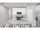 Modern kitchen features white cabinets, stainless steel appliances, granite countertops and a center island at 2718 Chestnut Creek Pl, Brandon, FL 33510