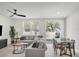 Bright living room with a view of the backyard, featuring a large sectional sofa and dining table at 2718 Chestnut Creek Pl, Brandon, FL 33510