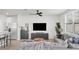 Modern living area with comfortable seating, sleek furnishings, and an open view of the kitchen at 2718 Chestnut Creek Pl, Brandon, FL 33510