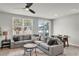 Inviting living room with comfortable seating, large windows, and an open flow to the dining area at 2718 Chestnut Creek Pl, Brandon, FL 33510