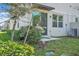 Outdoor patio with a hanging egg chair on a small concrete patio with lush green landscaping at 2718 Chestnut Creek Pl, Brandon, FL 33510
