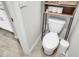 Toilet next to a wooden shelf and small white trashcan at 2718 Chestnut Creek Pl, Brandon, FL 33510
