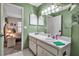Bathroom boasts a white single sink vanity, and green-painted walls with a glimpse of the bedroom at 2808 60Th W Ave # 1722, Bradenton, FL 34207