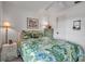 Bright bedroom featuring a floral-themed bed, dresser and table with lamps at 2808 60Th W Ave # 1722, Bradenton, FL 34207