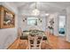 Dining room features hardwood floors, a glass table, and wicker chairs at 2808 60Th W Ave # 1722, Bradenton, FL 34207