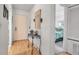 Entryway with light wood floors, decorative table, and view of a bedroom at 2808 60Th W Ave # 1722, Bradenton, FL 34207