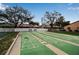 Shuffleboard court surrounded by mature trees and landscaping, great for recreation at 2808 60Th W Ave # 1722, Bradenton, FL 34207