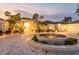 Grand circular driveway with a central fountain, surrounded by tropical landscaping and elegant home design at 282 Rue Des Lacs, Tarpon Springs, FL 34688