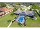 Gorgeous backyard featuring a screened-in pool, covered lanai, and lush landscaping for ultimate privacy at 282 Rue Des Lacs, Tarpon Springs, FL 34688