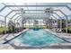 Inviting screened pool with fountains, chaise lounges, and serene water views for ultimate relaxation at 282 Rue Des Lacs, Tarpon Springs, FL 34688