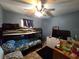 Bedroom with blue painted walls, a bunk bed, and a ceiling fan at 303 60Th W Ave, Bradenton, FL 34207