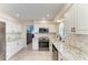 An open kitchen featuring white cabinetry, stainless steel appliances, and granite countertops at 3407 57Th Avenue W Dr, Bradenton, FL 34210