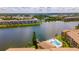 Scenic aerial view of community lake, pool, and condo buildings at 3525 Lake Bayshore Dr # 103J, Bradenton, FL 34205