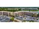 Aerial view shows buildings with parking and lake, offering convenient condo living in a community at 3525 Lake Bayshore Dr # 103J, Bradenton, FL 34205