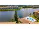 Aerial view of waterfront condos with a pool and lake access providing resort-style living at 3525 Lake Bayshore Dr # 103J, Bradenton, FL 34205