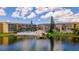 Beautiful aerial view of condos with pool, lush landscaping, and lake at 3525 Lake Bayshore Dr # 103J, Bradenton, FL 34205