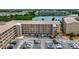 Aerial view shows building with parking and lake, offering convenient condo living in community at 3525 Lake Bayshore Dr # 103J, Bradenton, FL 34205