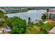 Beautiful aerial view of community buildings bordering a calm lake with manicured green spaces at 3525 Lake Bayshore Dr # 103J, Bradenton, FL 34205