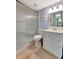 Clean bathroom with a glass-enclosed shower, white vanity, and soft blue walls for a refreshing feel at 3525 Lake Bayshore Dr # 103J, Bradenton, FL 34205