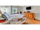 Bedroom featuring wood floors, dresser, and a sliding glass door to the outdoors at 3525 Lake Bayshore Dr # 103J, Bradenton, FL 34205