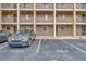 Exterior view of the condominium building shows parking and balconies, offering convenient city living at 3525 Lake Bayshore Dr # 103J, Bradenton, FL 34205