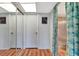 Bright hallway features wood floors, mirrored closet doors and access to the bathroom at 3525 Lake Bayshore Dr # 103J, Bradenton, FL 34205