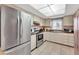 Efficient kitchen with stainless steel appliances, tile floors, and light-colored cabinetry at 3525 Lake Bayshore Dr # 103J, Bradenton, FL 34205