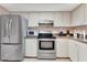 Bright kitchen featuring stainless steel appliances and tile flooring at 3525 Lake Bayshore Dr # 103J, Bradenton, FL 34205