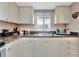 Kitchen featuring neutral cabinetry, stainless appliances, and granite countertops at 3525 Lake Bayshore Dr # 103J, Bradenton, FL 34205