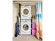Efficient laundry setup features a stacked washer and dryer unit with additional storage solutions at 3525 Lake Bayshore Dr # 103J, Bradenton, FL 34205