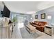 Bright living room with plenty of seating and natural light from screened patio at 3525 Lake Bayshore Dr # 103J, Bradenton, FL 34205