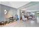 Open-concept living room with tiled flooring and views into the dining area for easy entertaining at 3525 Lake Bayshore Dr # 103J, Bradenton, FL 34205