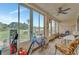Bright patio with a ceiling fan and comfortable seating overlooking lush greenery at 3525 Lake Bayshore Dr # 103J, Bradenton, FL 34205