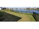 Large backyard with a pond view, offering a tranquil setting for relaxation and outdoor activities at 3677 Turning Tides Ter, Bradenton, FL 34208