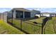 Fenced backyard with a well-maintained lawn and a view of neighboring homes, ideal for outdoor enjoyment at 3677 Turning Tides Ter, Bradenton, FL 34208