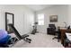 Well lit bedroom with an exercise bike and comfortable work space at 3677 Turning Tides Ter, Bradenton, FL 34208