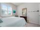 Cozy bedroom with shuttered windows, wood dresser, and nautical-themed decor at 3677 Turning Tides Ter, Bradenton, FL 34208